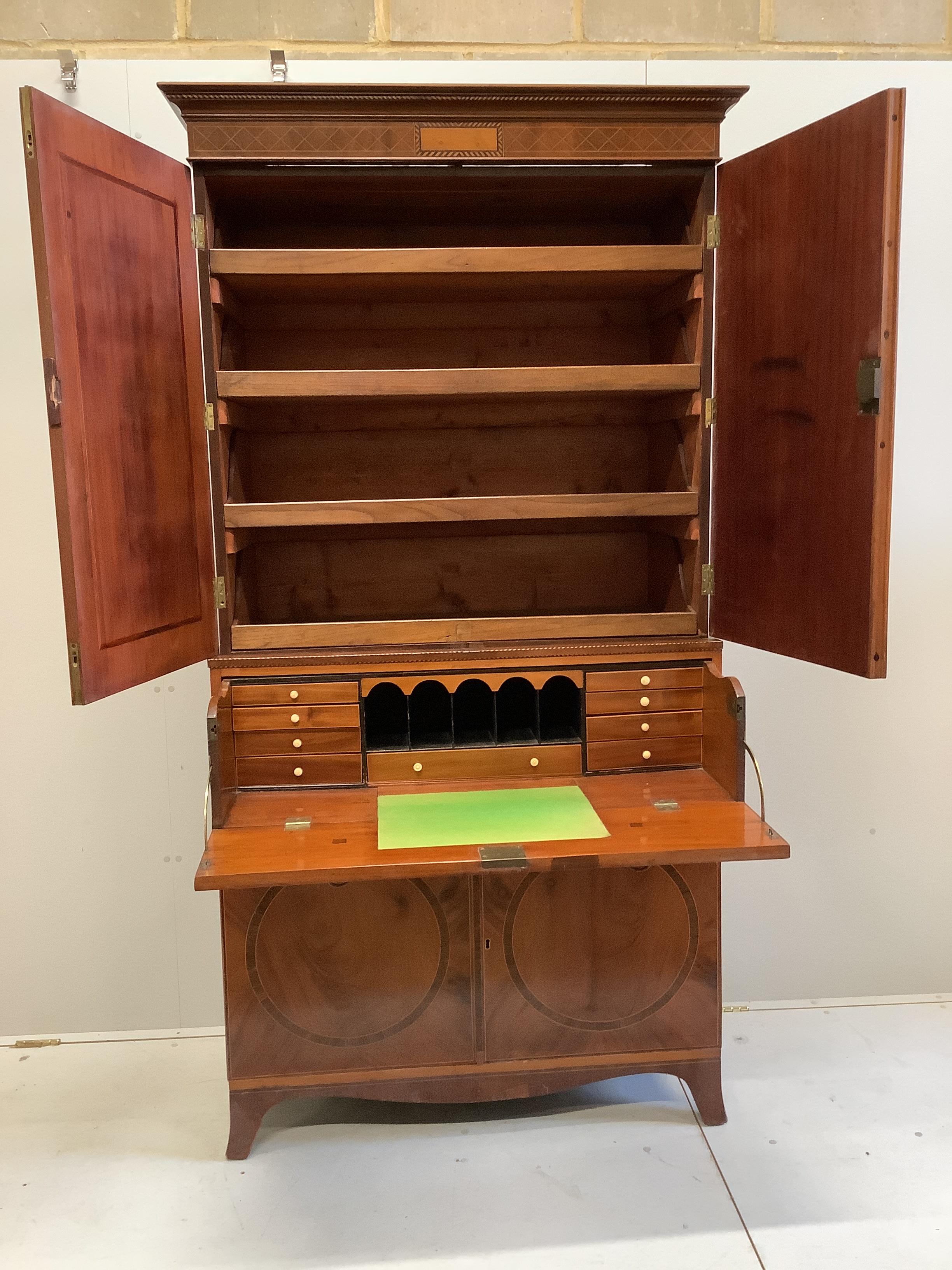 A George III style inlaid mahogany secretaire linen press, width 105cm, depth 50cm, height 211cm